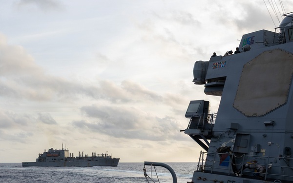 USS Mustin conducts a replenishment-at-sea with USNS Wally Schirra