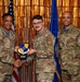 Three U.S. Air Force personnel pose for a formal award photo at what appears to be a recognition ceremony. The central figure is receiving a plaque bearing the '72d Air Base Wing' insignia, being presented by the individual on the left identified as 'HARRIS'. The individual on the right is identified as 'SUMMERS', and the recipient in the center wears an 'SF' (Security Forces) patch.