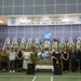 This image depicts the 50th Anniversary Ceremony honoring Major Arthur G. Bonifas and 1st Lieutenant Mark T. Barrett, two U.S. Army officers killed in the 1976 Korean DMZ axe murder incident. The ceremony is held at the Joint Security Area (JSA) and features military personnel, civilian attendees (likely family members), floral wreaths, and memorial displays. A banner in both English and Korean identifies the occasion, and multiple national flags are visible in the background.
