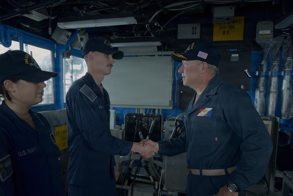 Rear Admiral Heames Shakes Junior Sailor’s Hand