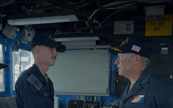 Rear Admiral Heames Shakes Junior Sailor’s Hand