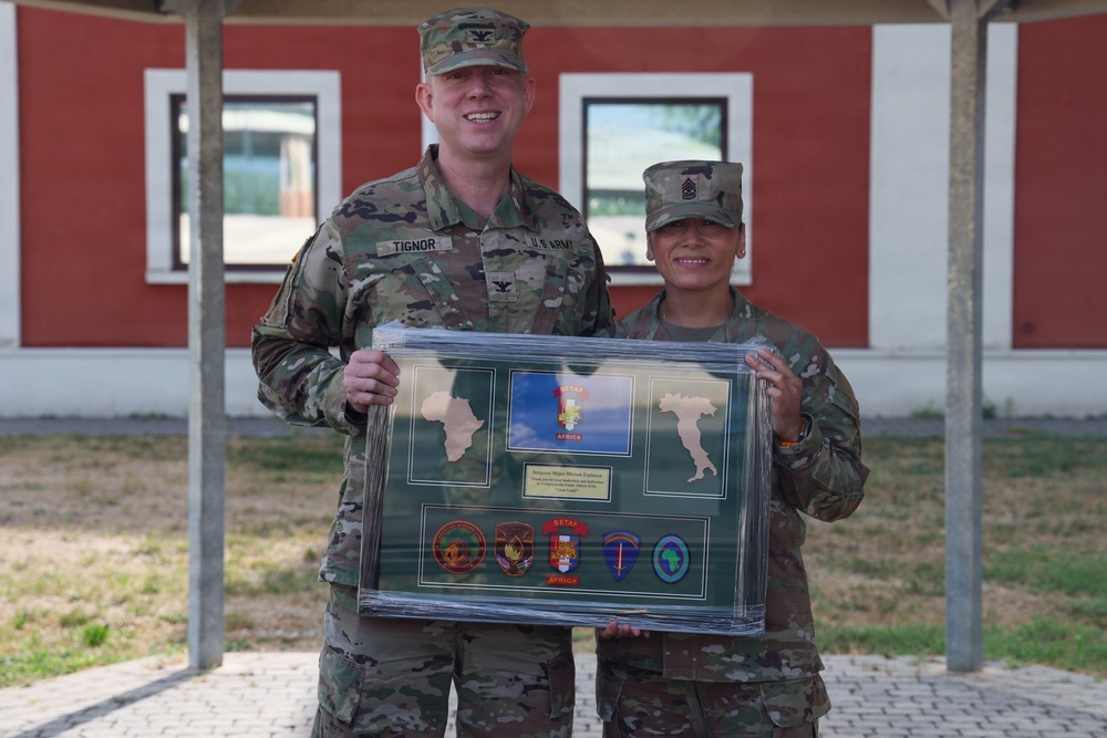 SETAF-AF public affairs team presents plaque to Sgt. Maj. Espinoza