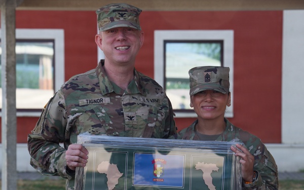 SETAF-AF public affairs team presents plaque to Sgt. Maj. Espinoza