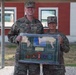 SETAF-AF public affairs team presents plaque to Sgt. Maj. Espinoza