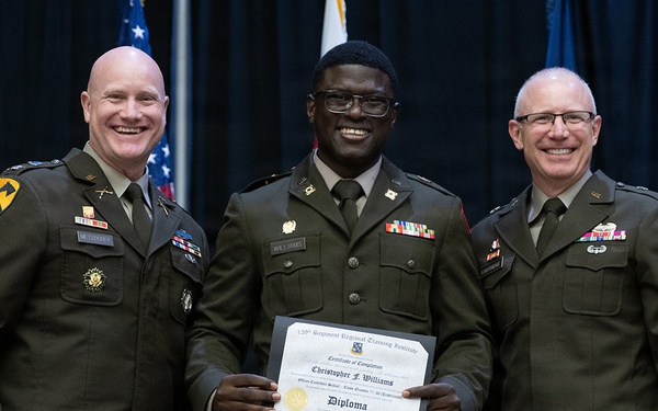 Three U.S. Army soldiers in dress green uniforms pose for a formal photo at a military graduation ceremony. The central figure, identified by his name tag as 'Williams,' holds a diploma from the 120th Regiment Regional Training Institute, Officer Candidate School, awarded to 'Christopher F. Williams.' Two senior officers flank him on either side, all three smiling.