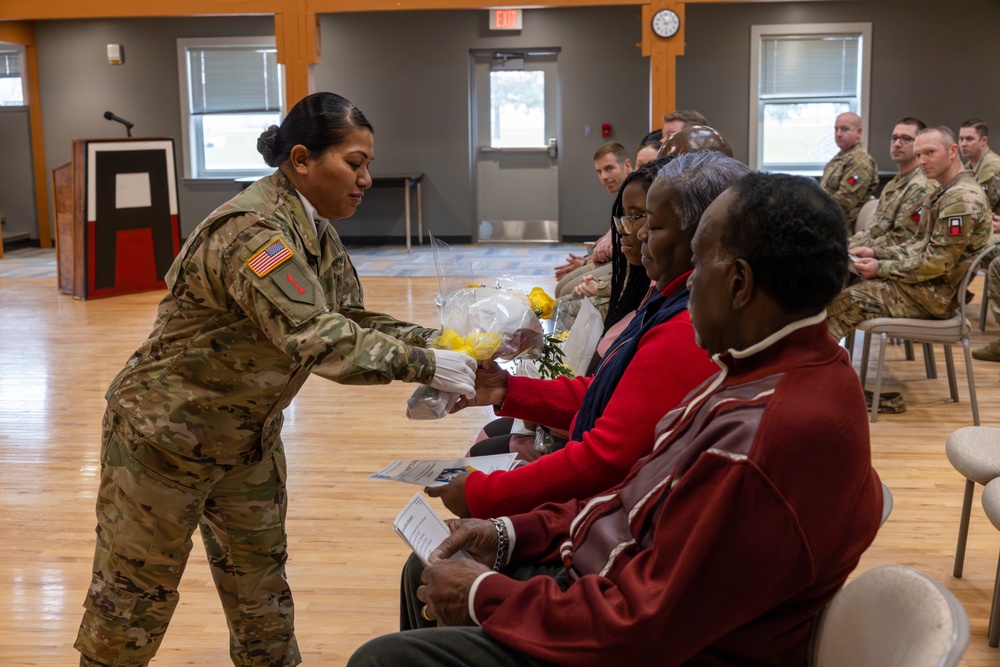 Soldier Gives Flowers to Family