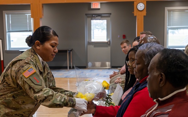 Soldier Gives Flowers to Family