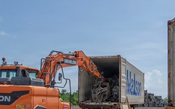 Solar panel debris from Super Typhoon Sinlaku being loaded into a shipping container.