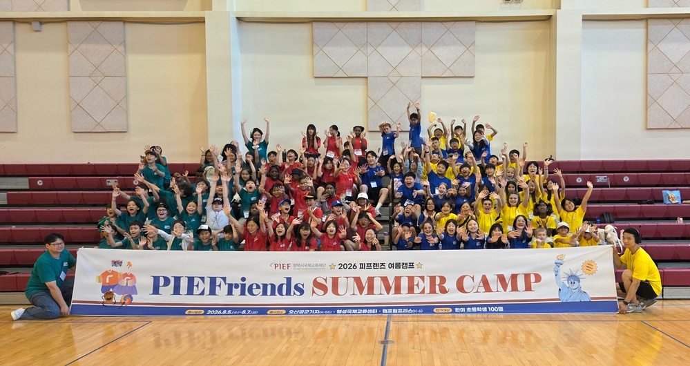 PIEFriends Summer Camp group photo at Camp Humphreys gymnasium, South Korea, 2026