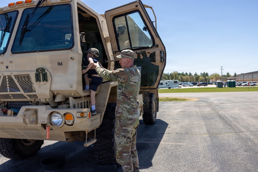 Soldier Helps Child Enter LMTV