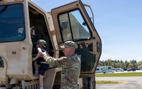 Soldier Helps Child Enter LMTV