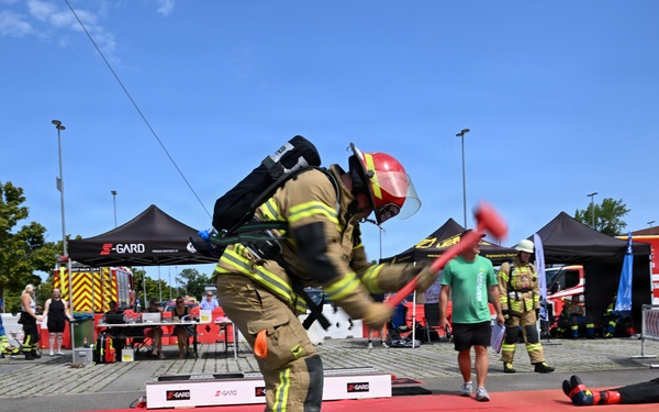 Firefighter Competes in S-GARD Combat Challenge Striking Event During Outdoor Fire Service Competition
