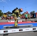 Firefighter Competes in S-GARD Combat Challenge Striking Event During Outdoor Fire Service Competition