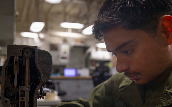 U.S. Marine Sews Squadron Patch on Flight Jacket