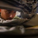 U.S. Marine Sews Squadron Patch on Flight Jacket