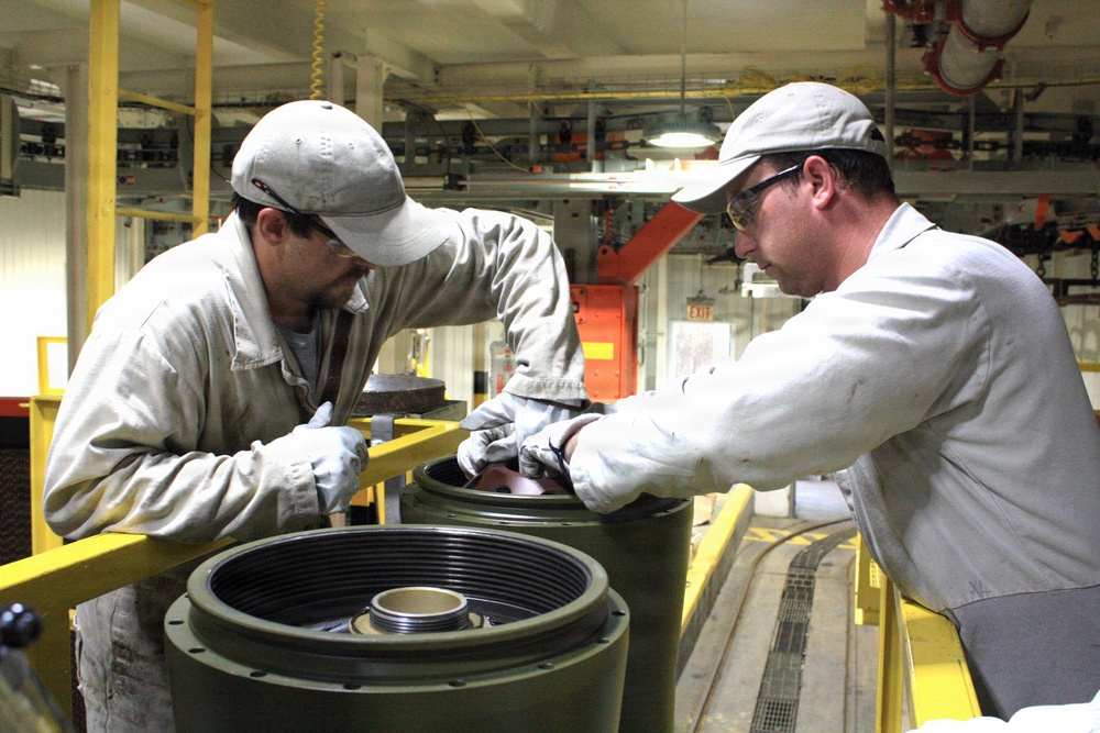 McAlester Army Ammunition Plant employees seal bombs as a part of the production process