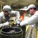 McAlester Army Ammunition Plant employees seal bombs as a part of the production process