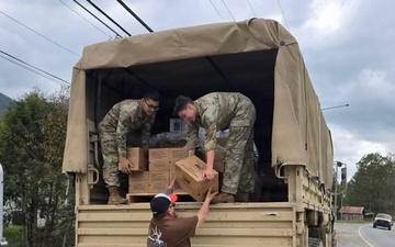 Soldiers deliver supplies in Asheville after Hurricane Helene.