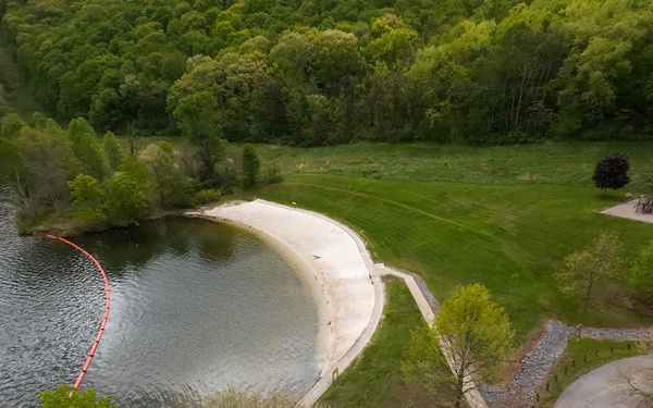 Volunteers and U.S. Army Corps of Engineers staff remove debris from the shoreline of Raystown Lake