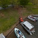 Volunteers and U.S. Army Corps of Engineers staff remove debris from the shoreline of Raystown Lake