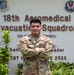 A U.S. Air Force service member named Chavez poses with arms crossed in front of the 18th Aeromedical Evacuation Squadron sign. The individual is wearing OCP (Operational Camouflage Pattern) uniform with visible name tape and U.S. Air Force tape. The photo appears to be an official or semi-official portrait taken outdoors at a military installation.
