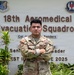 A U.S. Air Force service member named Chavez stands with arms crossed in front of the 18th Aeromedical Evacuation Squadron building sign. The individual is wearing an OCP (Operational Camouflage Pattern) uniform with visible name tape, U.S. Air Force tape, and rank insignia. The setting appears to be at a military installation, likely in the Pacific region based on the Pacific Air Forces emblem visible on the sign.