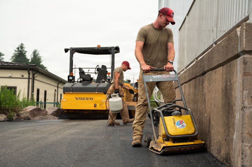 RED HORSE Airman compacts asphalt at Tobyhanna