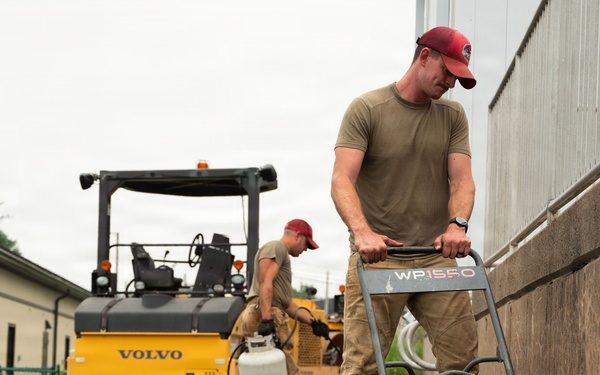 RED HORSE Airman compacts asphalt at Tobyhanna