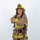 A firefighter in full turnout gear poses against a white background with arms crossed in a confident stance. The helmet displays 'ARFF FIREFIGHTER' and 'MCAS MIRAMAR', identifying this individual as an Aircraft Rescue and Firefighting specialist at Marine Corps Air Station Miramar. The subject is fully equipped with SCBA harness, reflective striping, and firefighting boots.
