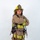 A firefighter in full turnout gear stands posed with arms crossed against a plain white background. The helmet displays 'ARFF' and 'FIREFIGHTER' markings, along with 'MCAS MIRAMAR', identifying this as an Aircraft Rescue and Firefighting specialist from Marine Corps Air Station Miramar. The image appears to be a professional portrait or official photograph.