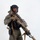 MCAS Marines pose for content 2026 A person in full tactical/military-style gear is posed against a plain white background in what appears to be a studio setting. They are equipped with a large rifle featuring a suppressor, optic scope, and coyote-tan finish, along with a sidearm holster and tactical vest. The image appears to be a professional or promotional photograph.