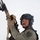 MCAS Marines pose for content 2026 A uniformed security or military personnel member is posed against a white background holding a rifle upward. The individual is wearing full tactical gear including a ballistic helmet, plate carrier vest, and a patch identifying 'MCAS Miramar SRT' (Special Reaction Team). The image appears to be a professional portrait or promotional photograph.