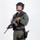 MCAS Marines pose for content 2026 A uniformed tactical law enforcement officer stands in a studio setting against a white background. He is fully equipped with tactical gear, body armor, communications equipment, and is holding an assault-style rifle. A patch on his left sleeve and a badge on his chest suggest law enforcement affiliation, likely a SWAT or SRT (Special Response Team) unit.