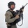MCAS Marines pose for content 2026 A soldier or tactical operator is posed against a plain white/light gray studio background in full combat gear. The subject is holding an assault rifle in a ready position while looking toward the camera. The image appears to be a professional studio photograph, likely for editorial, stock, or promotional purposes.