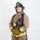 MCAS Marines pose for content 2026 A firefighter in full personal protective equipment (PPE) stands in a formal portrait pose against a white background. The individual is wearing ARFF (Aircraft Rescue and Firefighting) gear from MCAS Miramar, identified as a Lead Firefighter. They are holding a breathing apparatus face mask and have SCBA (Self-Contained Breathing Apparatus) equipment on their back.