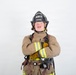 A firefighter in full turnout gear poses with arms crossed against a plain white background. The helmet is black and clearly marked 'ARFF' and 'MCAS MIRAMAR' with the designation 'LEAD FIREFIGHTER'. The image appears to be a professional portrait or official photo.