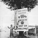 A black-and-white World War II photograph dated 5th September 1944, showing Corporal Charles H. Johnson of the 783rd Military Police Battalion standing beside a large Red Ball Highway promotional sign in Alençon, France. The sign encourages convoy drivers to meet tonnage targets and keep supplies moving toward Allied forces. The image is a well-documented historical record of the famous Red Ball Express logistics operation.