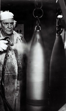 Historical McAlester Army Ammunition Plant photo circa 1940's-employee painting on the bomb line.