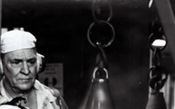 Historical McAlester Army Ammunition Plant photo circa 1940's-employee painting on the bomb line.