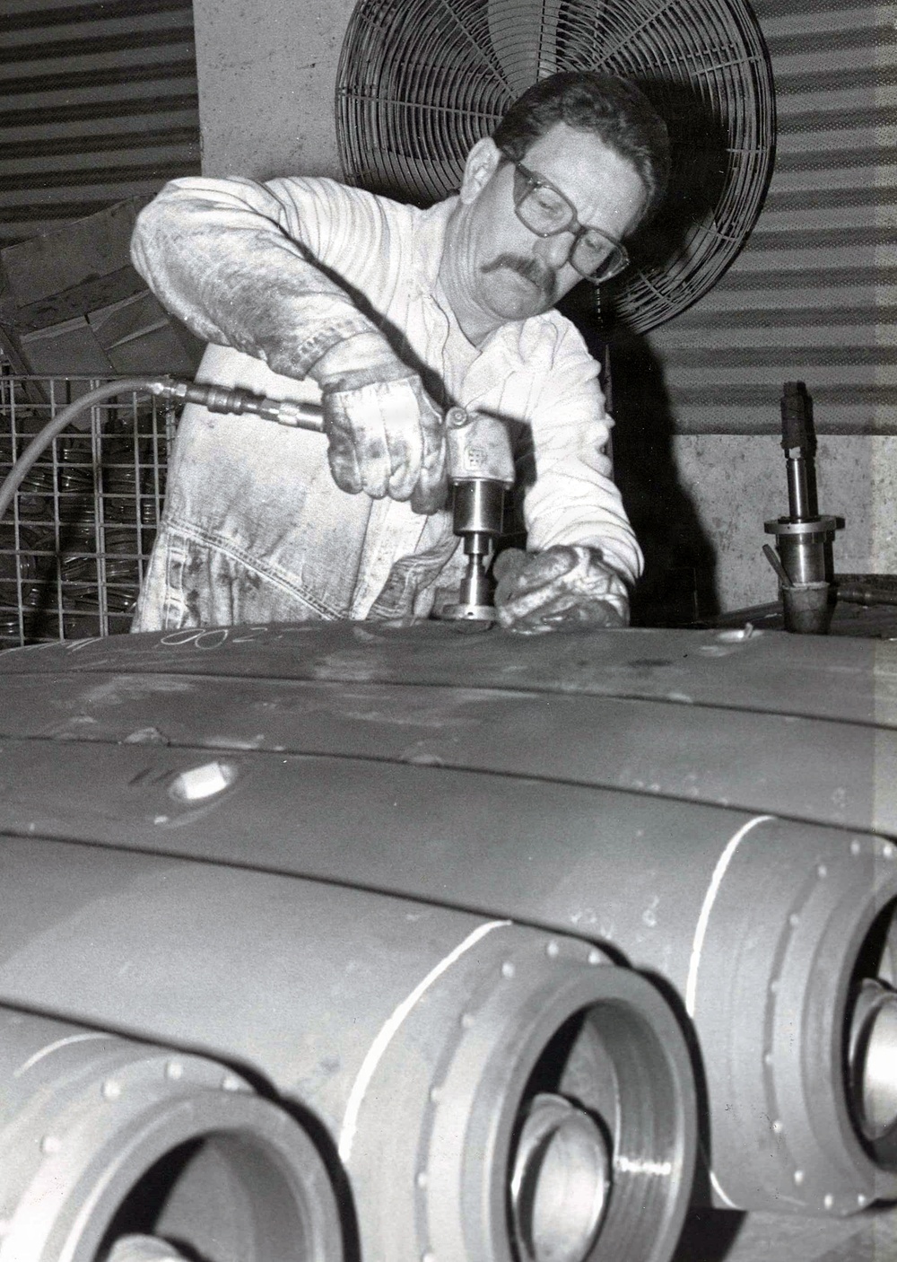 Historical McAlester Army Ammunition Plant photo - bomb line employee removes shipping plug