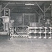 Historical McAlester Army Ammunition Plant photo - circa 1940's- people working on bomb line-moving bomb body with tug