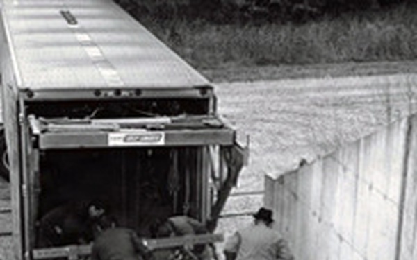 Historical McAlester Army Ammunition Plant photo - employees on loading dock inspecting bomb shipment