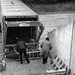 Historical McAlester Army Ammunition Plant photo - employees on loading dock inspecting bomb shipment
