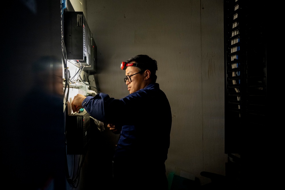 Information Systems Technician Inspects Wiring at Base Galveston