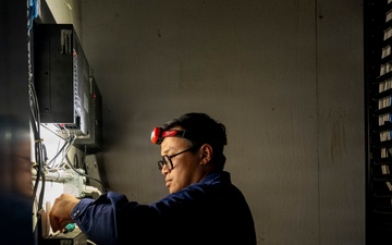 Information Systems Technician Inspects Wiring at Base Galveston