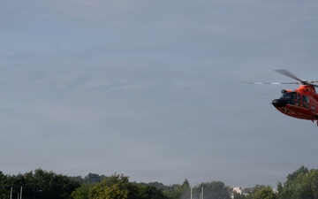 U.S. Coast Guard MH-65 Dolphin helicopter and response boats conduct joint patrol operations on inland waterway