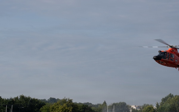 U.S. Coast Guard MH-65 Dolphin helicopter and response boats conduct joint patrol operations on inland waterway