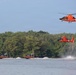 U.S. Coast Guard MH-65 Dolphin helicopters and response boats conduct joint operations on inland waterway