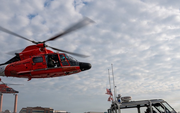 U.S. Coast Guard helicopters and armed patrol boat conduct joint operations on the Potomac River near Washington, D.C.