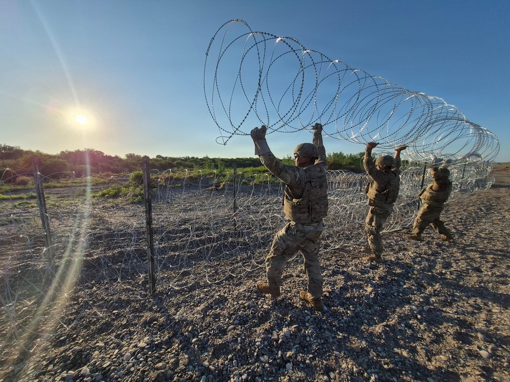 The 350th Engineer Company installs triple-standard concertina wire